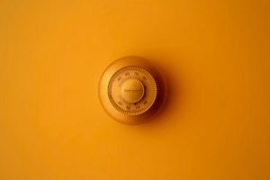 thermostat against orange wall